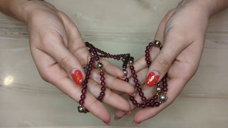 Long necklace with transluscent red-violet beads and gold accents - Artful Accumulator Boutique Vintage