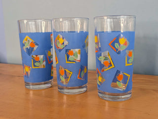 Small tumblers with framed multicolor abstract tulips in a blue background, set of 3