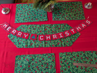 "Merry Christmas" Plastic Canvas Banner with green, red, and white stitched yarn