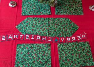 "Merry Christmas" Plastic Canvas Banner with green, red, and white stitched yarn