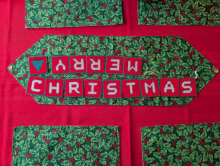 "Merry Christmas" Plastic Canvas Banner with green, red, and white stitched yarn