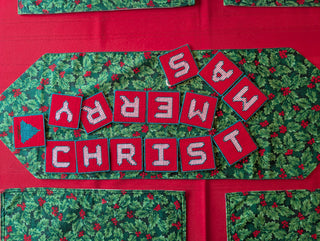 "Merry Christmas" Plastic Canvas Banner with green, red, and white stitched yarn