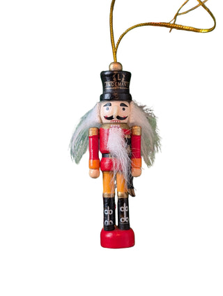 Wooden nutcracker ornament with a black hat on white background