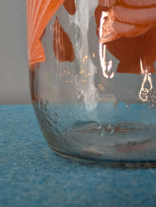 Seashells on a glass storage jar with orange plastic lid - Artful Accumulator Boutique Vintage