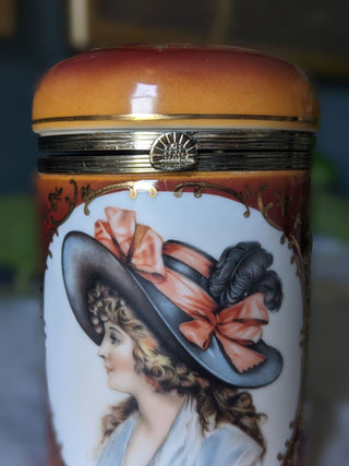 Trinket bureau jar with 24kt gold lustre and a decal of a beautiful woman in a feathered hat with curly hair and bows. Brass clasp & hinge. -  - #tag1# - #tag2# - #tag3# - #tag4# - the Artful Accumulator's Vintage Boutique