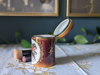 Trinket bureau jar with 24kt gold lustre and a decal of a beautiful woman in a feathered hat with curly hair and bows. Brass clasp & hinge. -  - #tag1# - #tag2# - #tag3# - #tag4# - the Artful Accumulator's Vintage Boutique