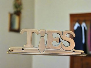 Brass "Ties" tie holder mountable to wall