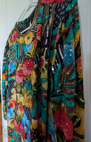 Multicolour sequin layered dress with sheer fabric, bright florals, and a beaded neackline
