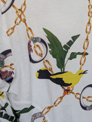 Modern * white zip up cardigan with imagery of jewels, gold chains, and yellow birds