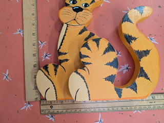 adorable orange cartoon tiger with black stripes on wood, signed on the back