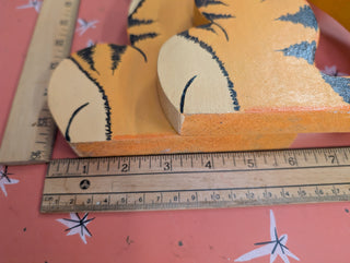 adorable orange cartoon tiger with black stripes on wood, signed on the back