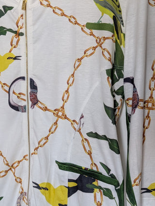 Modern * white zip up cardigan with imagery of jewels, gold chains, and yellow birds