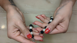 Black, white, and silver beaded necklace with oblong beads