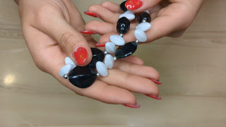 Black, white, and silver beaded necklace with oblong beads