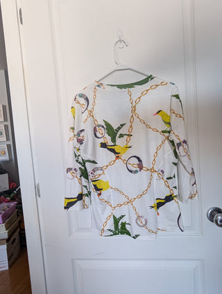 Modern * white zip up cardigan with imagery of jewels, gold chains, and yellow birds